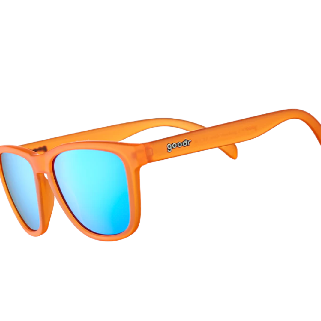 Orange sunglasses with blue lenses on a white background. Available at Be Charmed