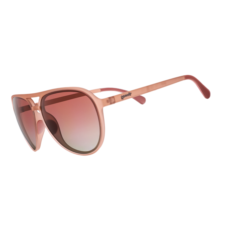 A pair of translucent pink sunglasses with rose gradient lenses. Available at Be Charmed