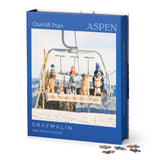 Gray Malin 'Chairlift Pups' Aspen puzzle packaging with dogs on a ski lift. Available at Be Charmed
