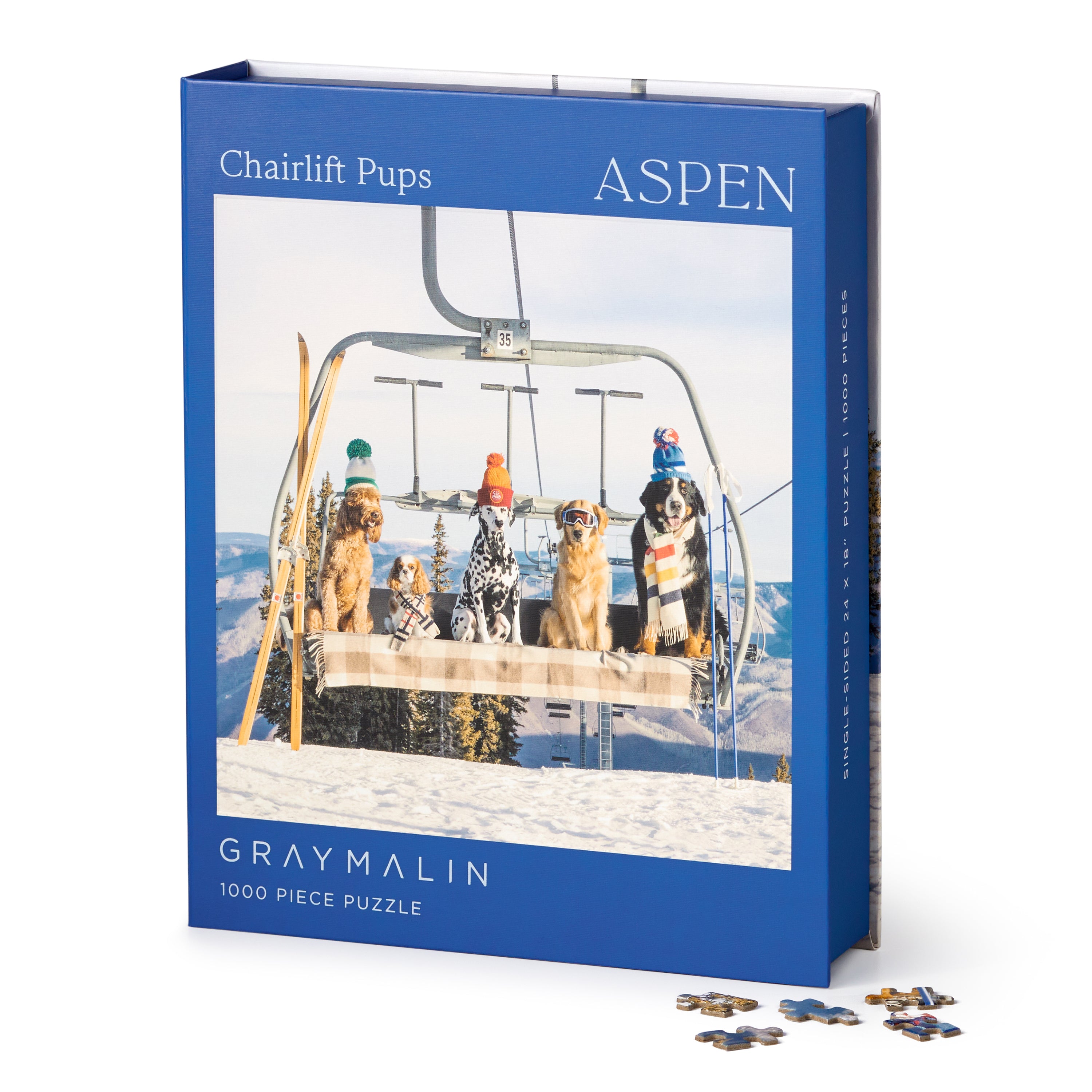Gray Malin 'Chairlift Pups' Aspen puzzle packaging with dogs on a ski lift. Available at Be Charmed