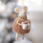 Felted mouse ornament with a bow, hanging against a blurred snowy background. Available at Be Charmed