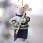 Felted mouse ornament in hockey gear hanging against a blurred snowy background. Available at Be Charmed