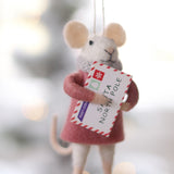 Decorative mouse ornament holding a letter with a blurred Christmas tree background. Available at Be Charmed