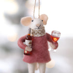 Decorative mouse ornament holding a bottle and glass against a blurred background. Available at Be Charmed