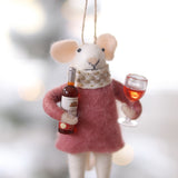 Decorative mouse ornament holding a bottle and glass against a blurred background. Available at Be Charmed