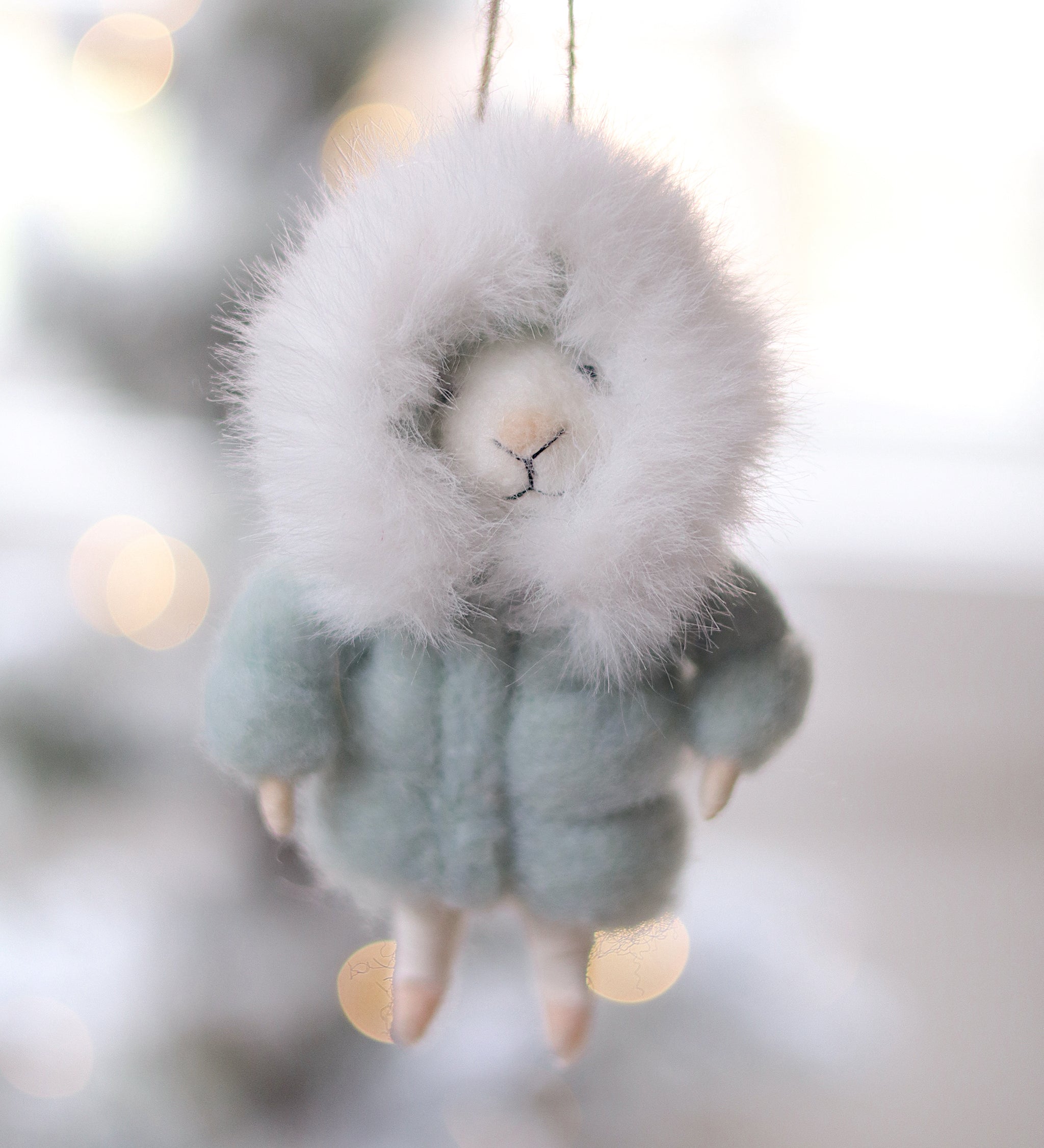 Felted mouse ornament hanging against a blurred snowy background.  Available at Be Charmed