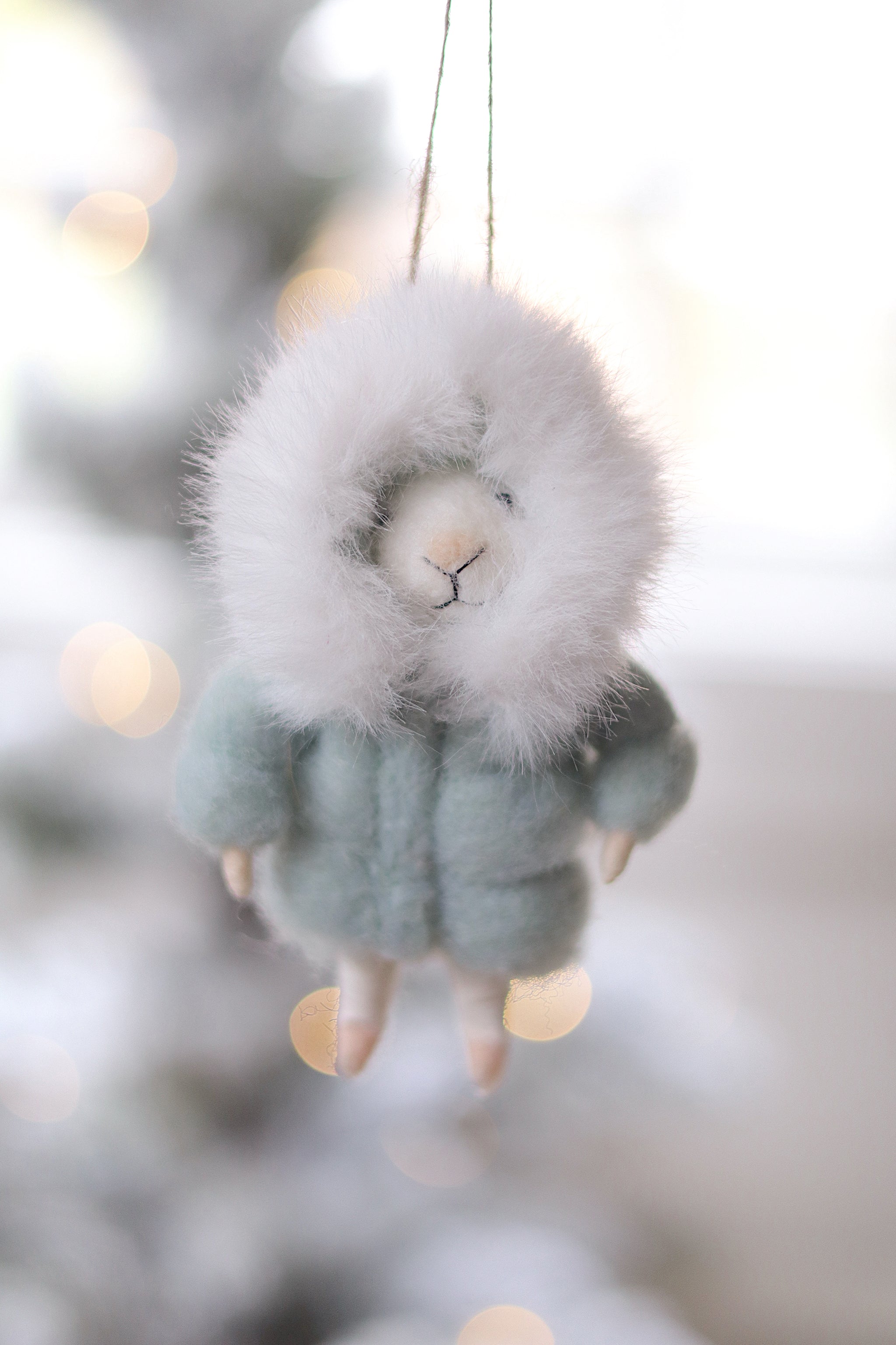Felted mouse ornament hanging against a blurred snowy background.  Available at Be Charmed