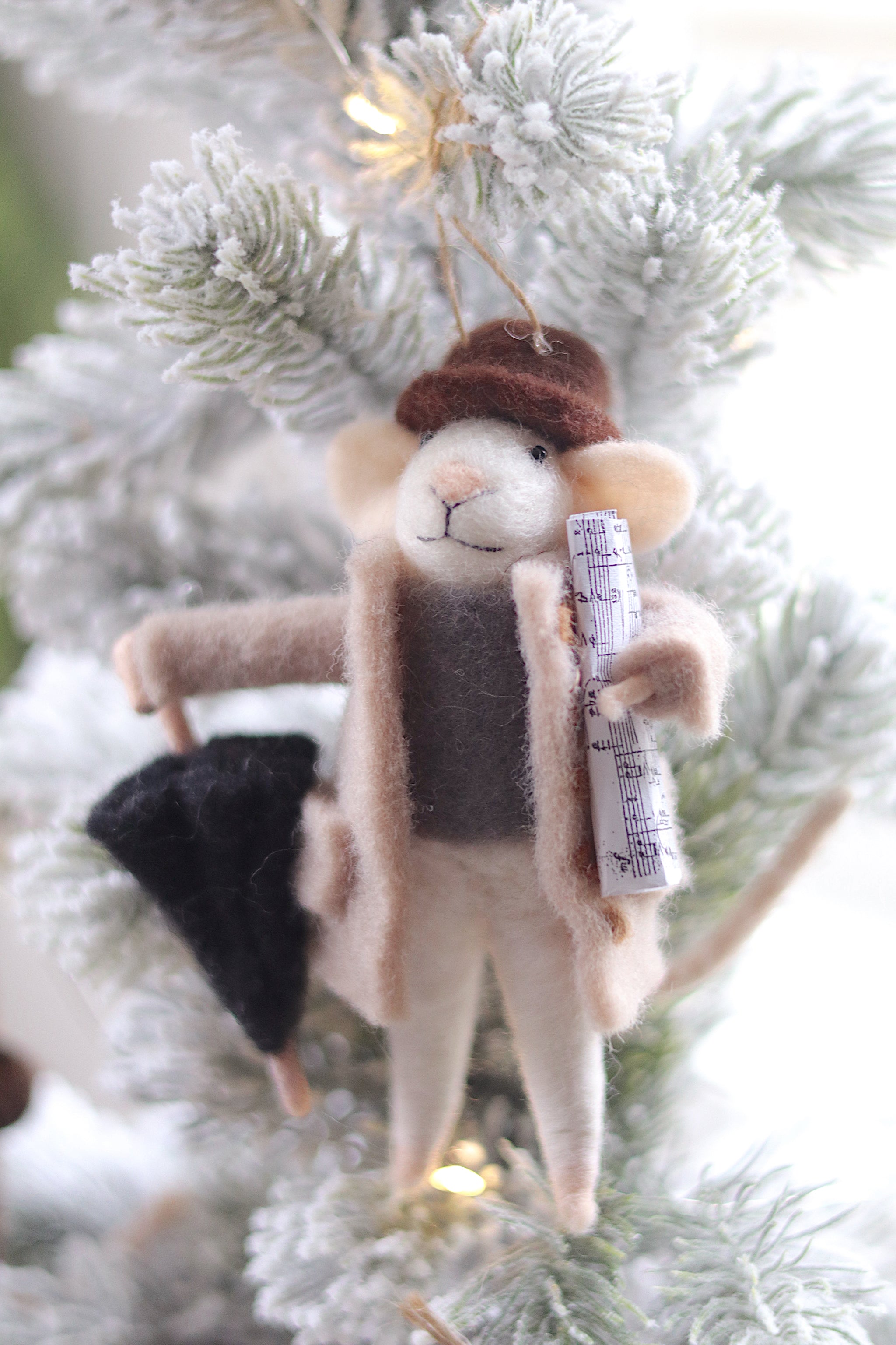 Plush mouse ornament with a hat and scarf on a Christmas tree. Available at Be Charmed
