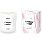 Homesick Peppermint Season candle and packaging on a beige background. Available at Be Charmed. 