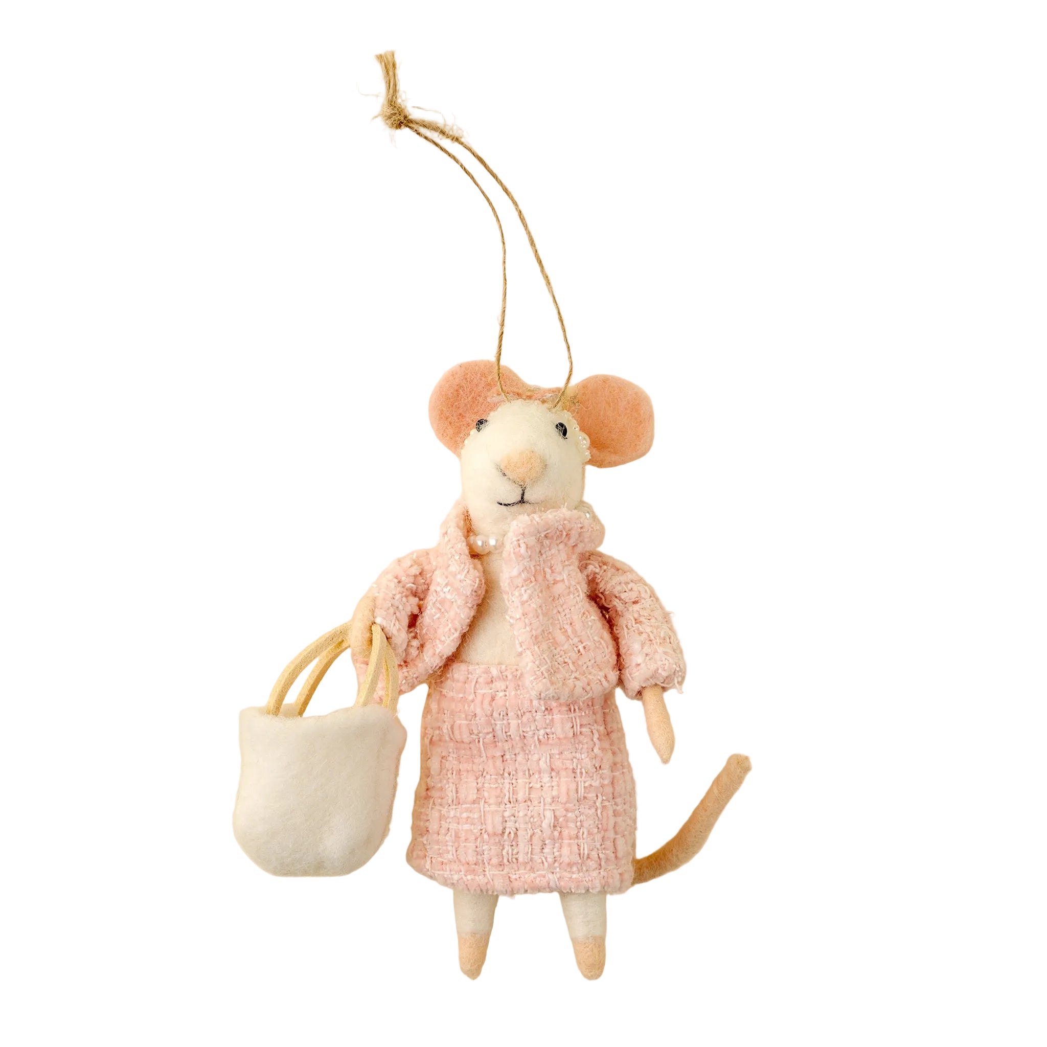 Mouse ornament in a pink coat holding a white bag on a beige background