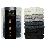 Set of black, gray, and white scrunchies with a container labeled 'Grab & Go Erickson Scrunchie' on a white background. Available at Be Charmed