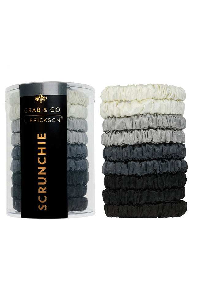 Set of black, gray, and white scrunchies with a container labeled 'Grab & Go Erickson Scrunchie' on a white background. Available at Be Charmed