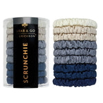 Set of scrunchies in blue and gray with a container labeled 'Grab & Go Erickson' on a white background. Available at Be Charmed
