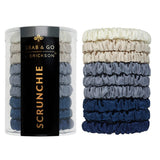 Set of scrunchies in blue and gray with a container labeled 'Grab & Go Erickson' on a white background. Available at Be Charmed