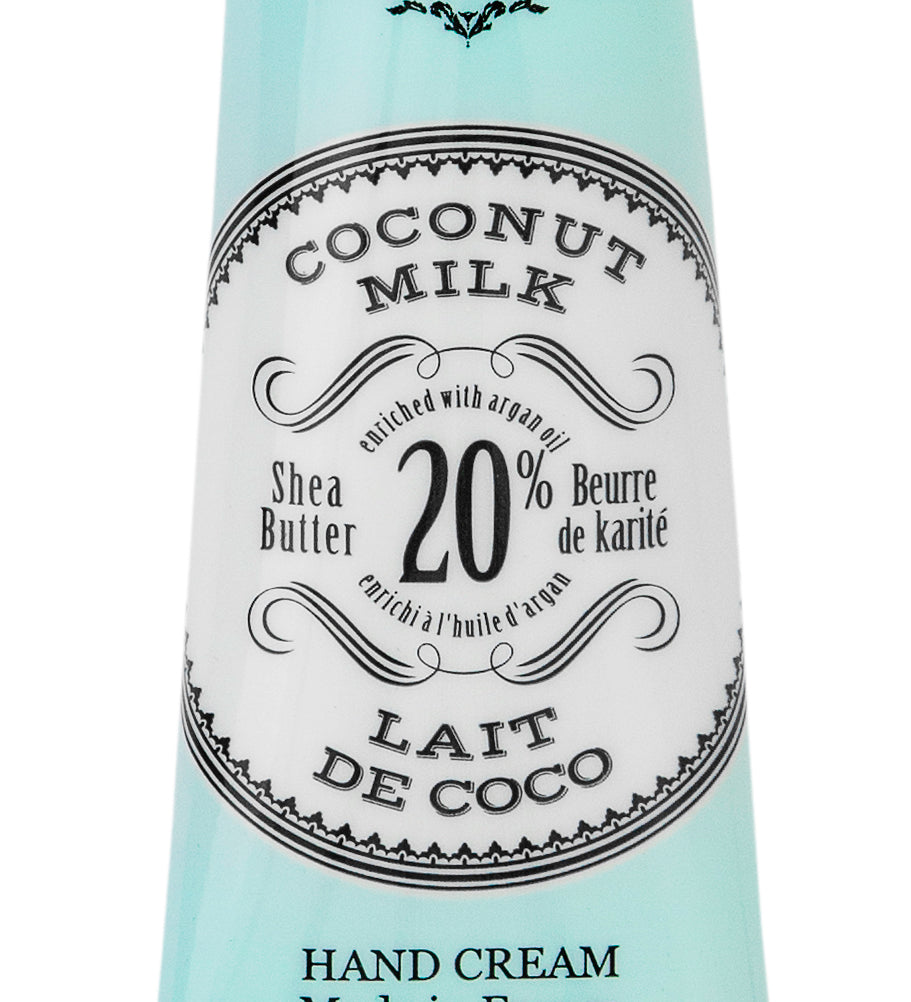 Hand cream tube labeled 'Coconut Milk' with branding on a white background. Available at Be Charmed