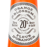 Hand cream tube labeled 'Orange Blossom' by L'Chanteclaire on a white background. Available at Be Charmed