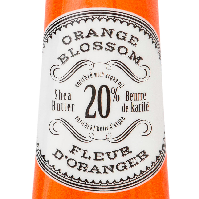 Hand cream tube labeled 'Orange Blossom' by L'Chanteclaire on a white background. Available at Be Charmed