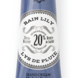 Hand cream tube labeled 'Lys de Pluie' with blue and white packaging on a white background Available at Be Charmed