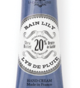 Hand cream tube labeled 'Lys de Pluie' with blue and white packaging on a white background Available at Be Charmed