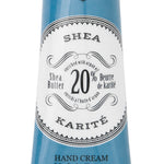 Hand cream tube with blue and white label on a white background. Available at Be Charmed