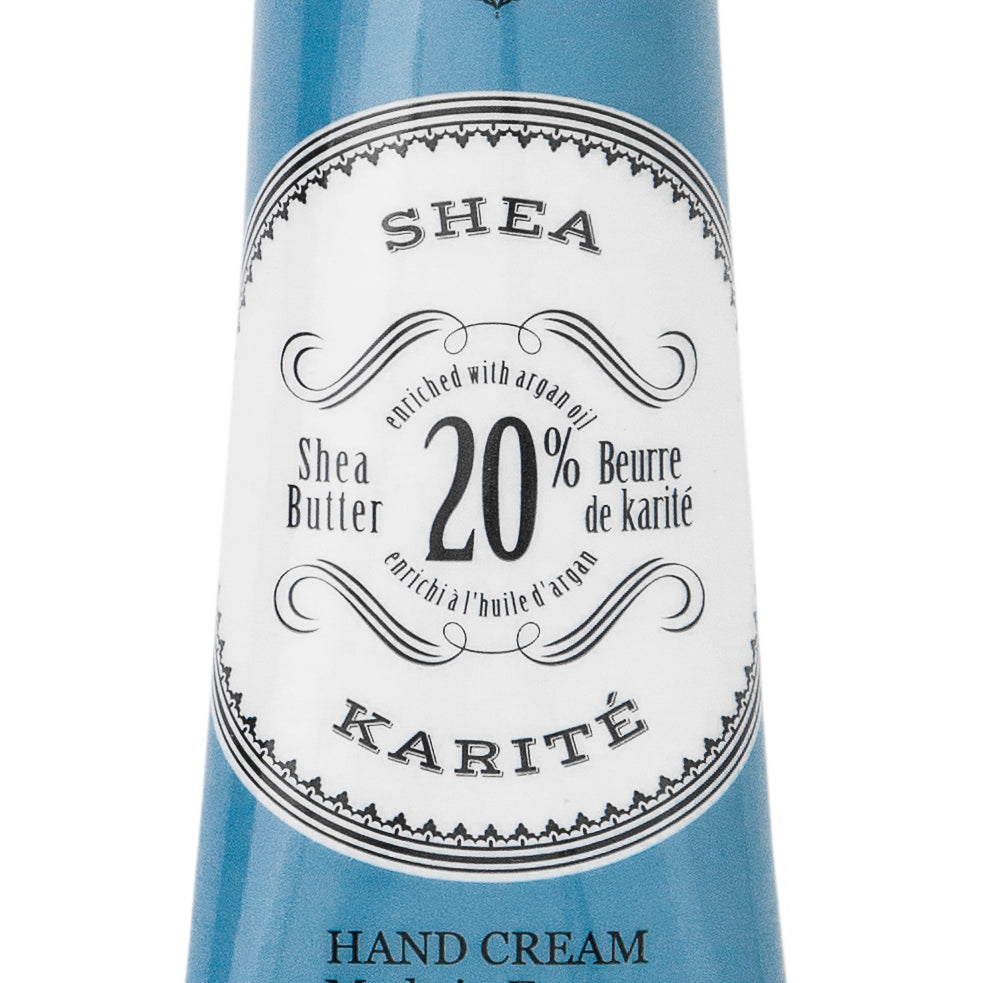 Hand cream tube with blue and white label on a white background. Available at Be Charmed