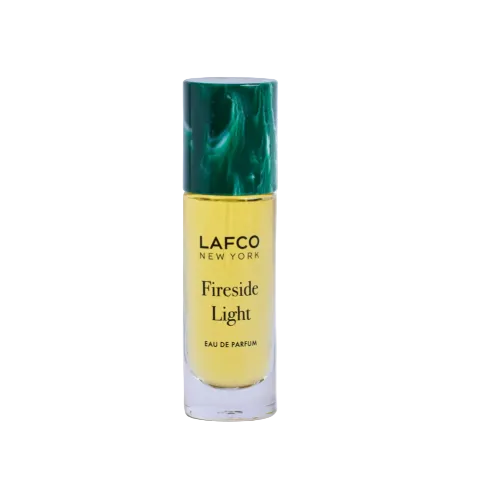 LAFCO New York Fireside Light Eau de Parfum in a clear cylindrical bottle with a dark green marbled cap, set against a plain white background. Available at Be Charmed