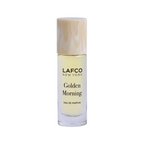 A small cylindrical glass bottle of LAFCO New York Golden Morning Eau de Parfum with a marbled beige cap, set against a plain white background. Available at Be Charmed