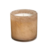 A single-wick candle in a cylindrical amber glass jar with subtle gold flecks and a white wax fill, photographed on a clean white background. Available at BE Charmed