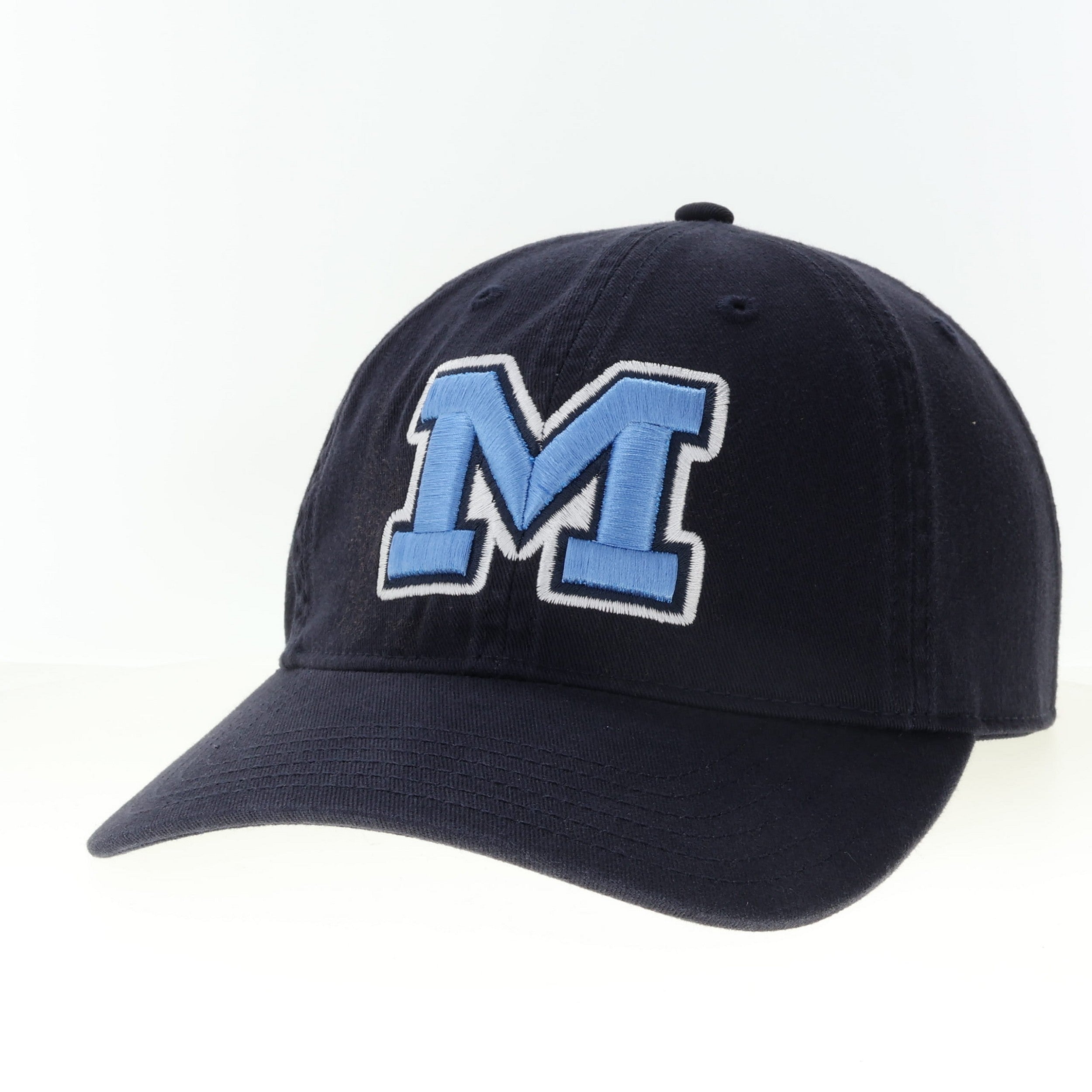 Navy blue cap with a large blue 'M' on a white background. Available at Be Charmed