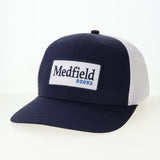 Navy and white cap with 'Medfield 02052' logo on a white background. Available at Be Charmed