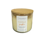 Candle jar with a wooden lid and vanilla pumpkin label on a white background. Available at Be Charmed. 