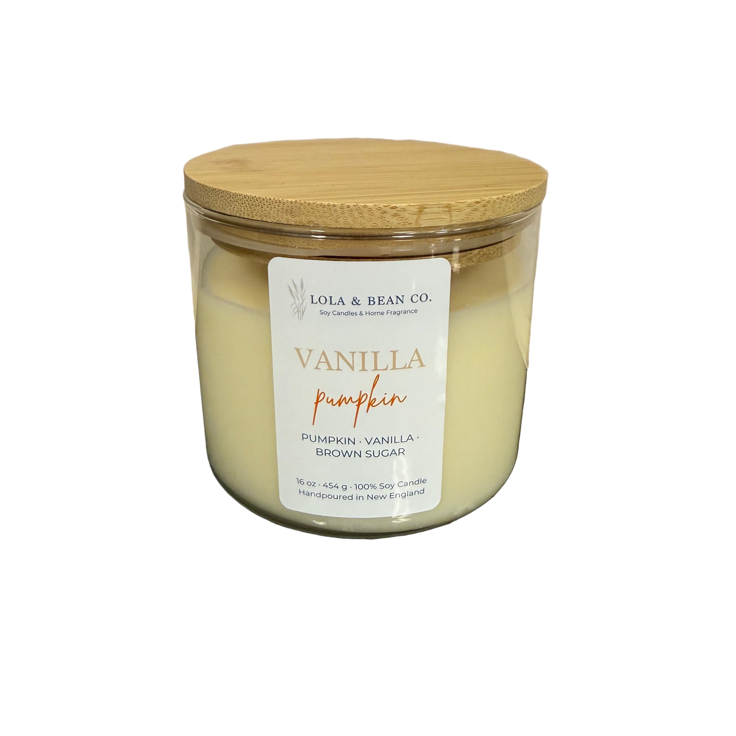 Candle jar with a wooden lid and vanilla pumpkin label on a white background. Available at Be Charmed. 