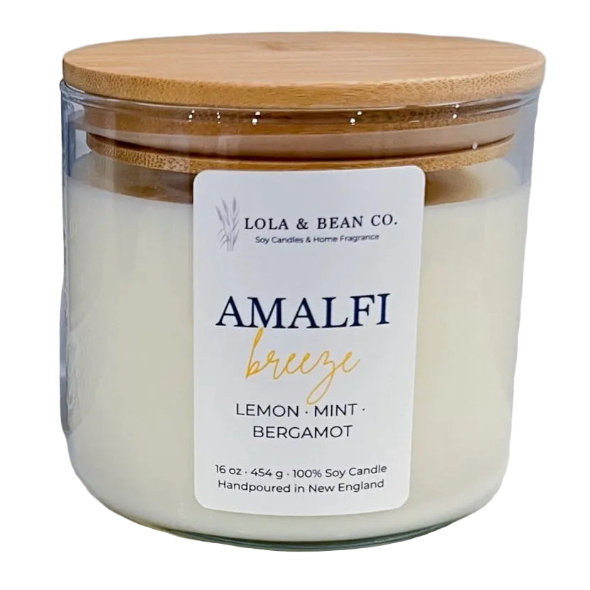 Candle jar with wooden lid and 'Lola & Bean Co.' label on a white background. Available at Be Charmed