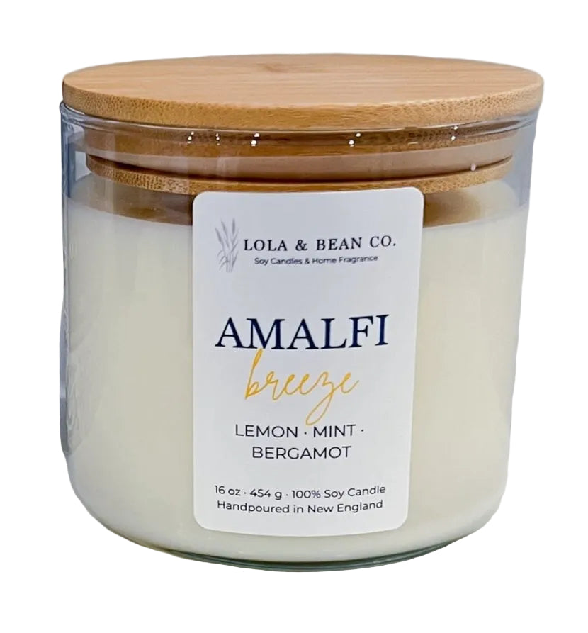 Candle jar with wooden lid and 'Lola & Bean Co.' label on a white background. Available at Be Charmed