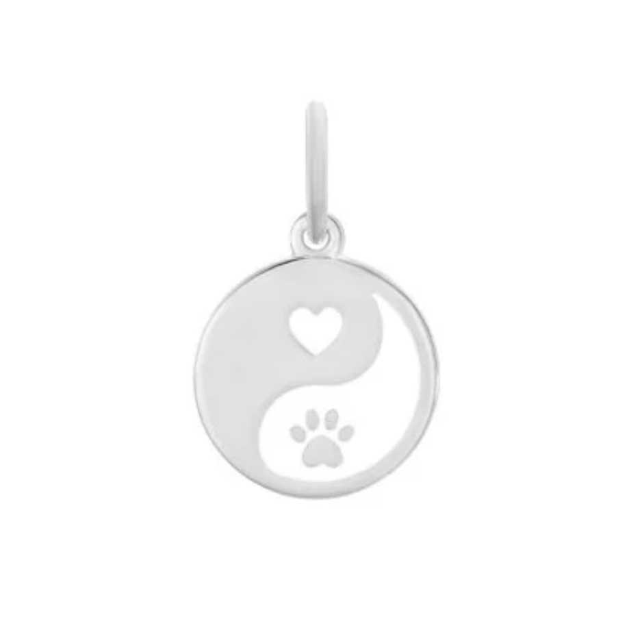 Silver pendant with yin yang design featuring a heart and paw print on a white background. Available at Be Charmed. 