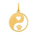 Gold pendant with yin yang design featuring a heart and paw print on a white background. Available at Be Charmed. 