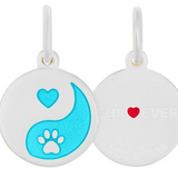 Round white pendants with yin yang design and heart paw print on a white background. Available at Be Charmed. 