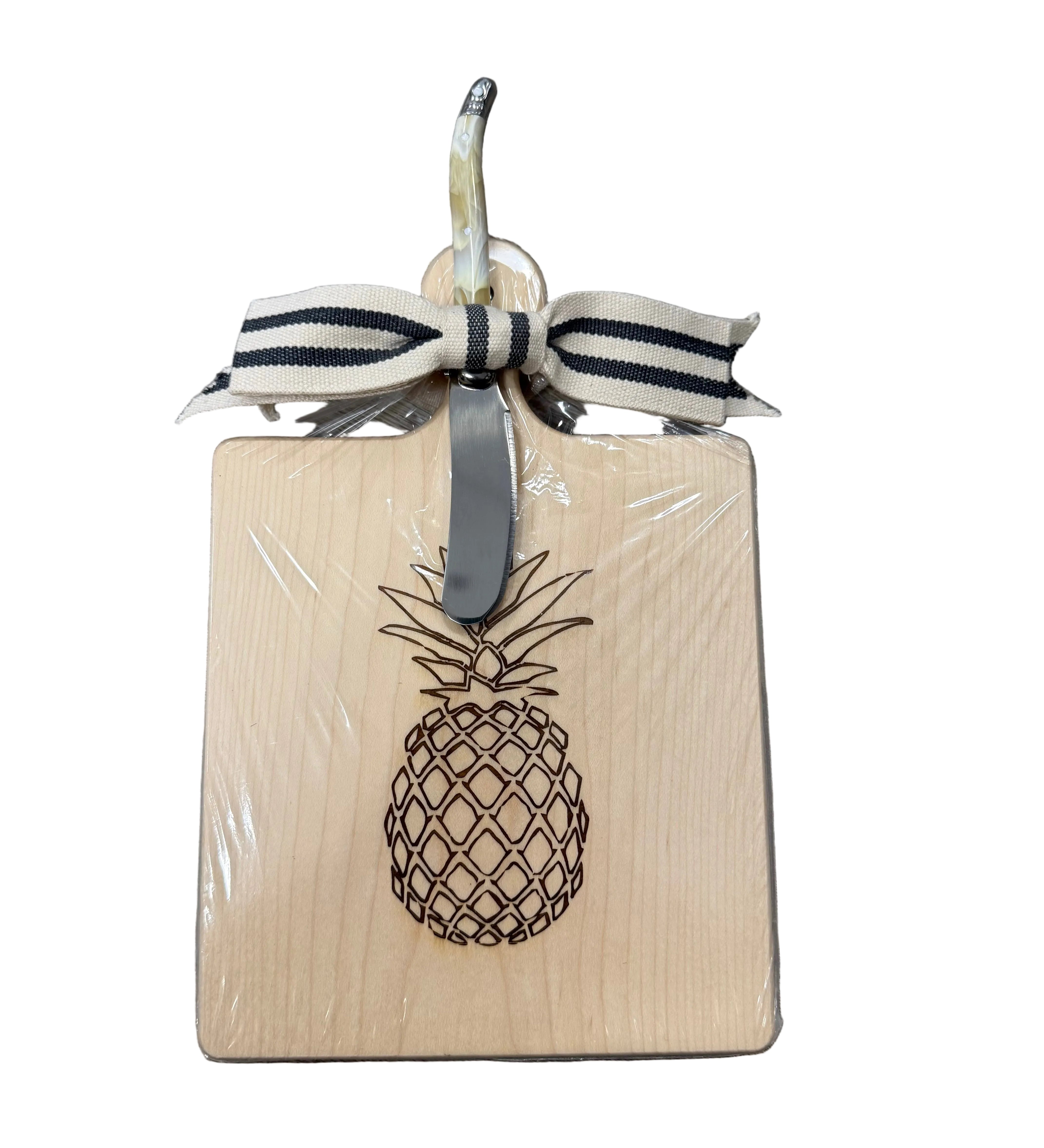 Square wooden cutting board with pineapple design and ribbon on a white background. Available at Be Charmed