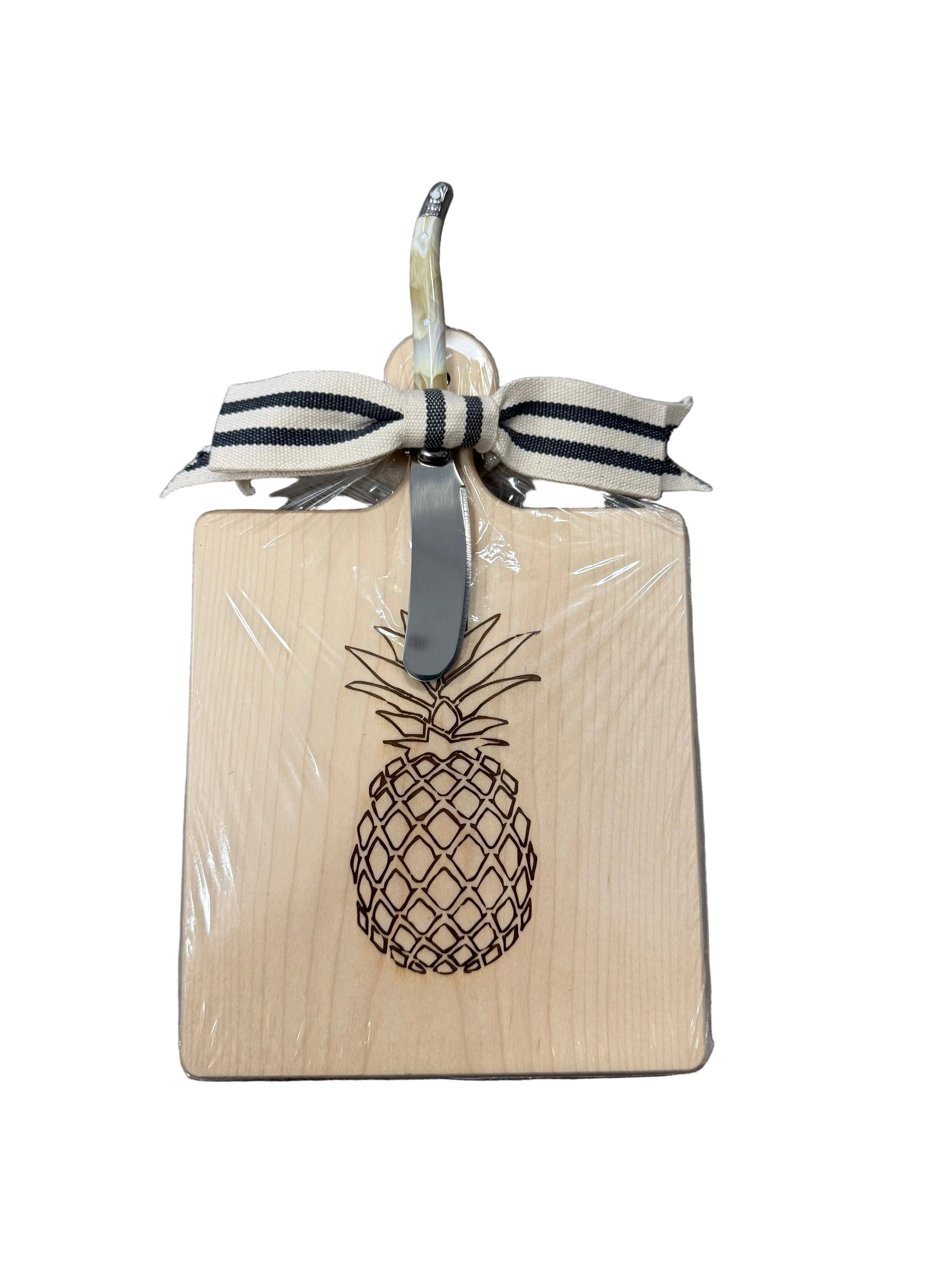 Square wooden cutting board with pineapple design and ribbon on a white background. Available at Be Charmed