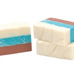 Three bars of soap with layered colors on a white background. Available at Be Charmed