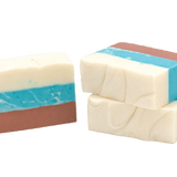 Three bars of soap with layered colors on a white background. Available at Be Charmed