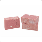 Pink soap bar with decorative design on a white background. Available at Be Charmed