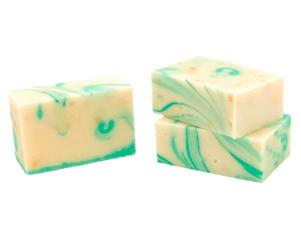 Three blocks of soap with green swirls on a white background. Available at Be Charmed