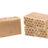 Two beige soap bars with honeycomb texture on a white background. Available at Be Charmed