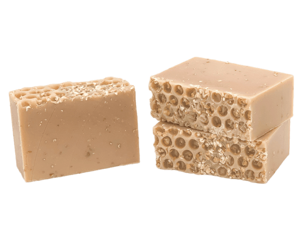 Two beige soap bars with honeycomb texture on a white background. Available at Be Charmed