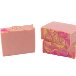 Two pink soap bars with marbled patterns on a white background. Available at Be Charmed