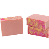 Two pink soap bars with marbled patterns on a white background. Available at Be Charmed