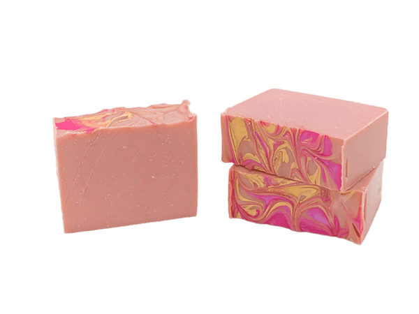 Two pink soap bars with marbled patterns on a white background. Available at Be Charmed