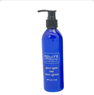 Blue lotion bottle with pump labeled 'Molly's' on a white background. Available at Be Charmed