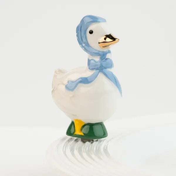 Decorative duck mini with a blue hood and green feet on a white background. Available at Be Charmed